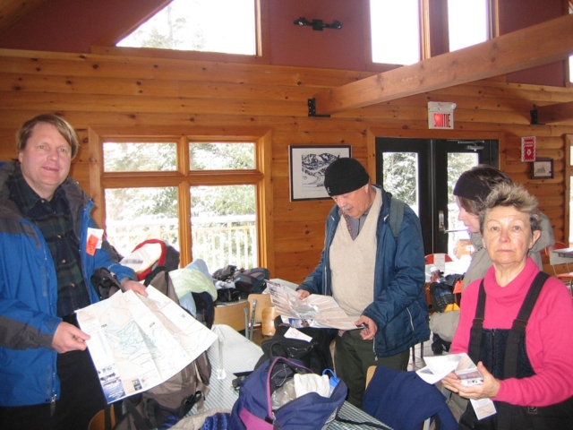Comparing trail maps before beginning a day's skiing: Brian O'Konski, Carl Modig and Bozena Sarneka-Crouch