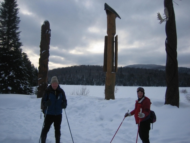 Modern totem poles on the shore of Lake Monroe within Mont Tremblant National Park